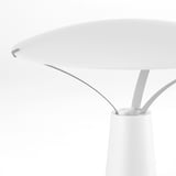Modern led table lamp with sleek, curved design and white finish, emitting soft decorative light.