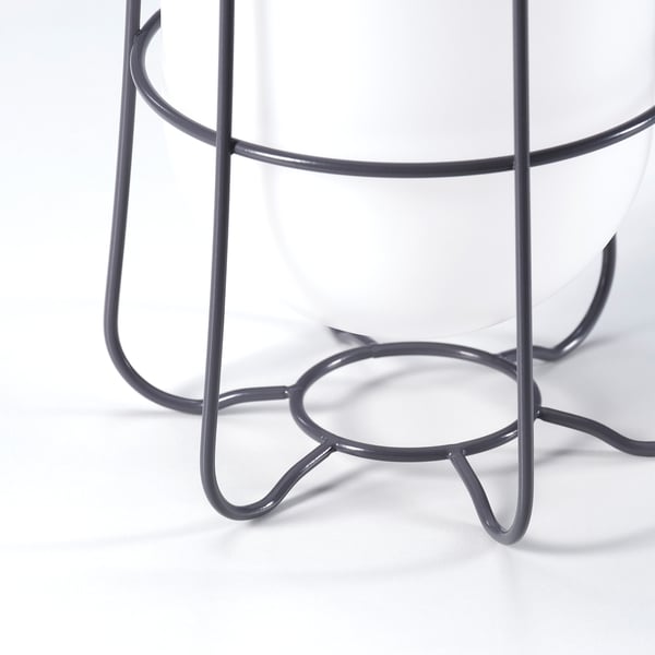Modern, white table lamp with grey metal base and hooks, showcasing sleek design and quality materials.