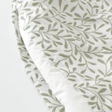Leaf-patterned duvet cover with press-stud closure, made from recycled polyester and cotton, offering breathability and moisture absorption.