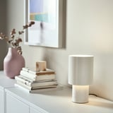 SPETSBOJ lamp on shelf with books and vase.