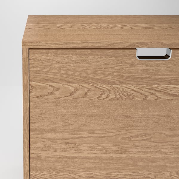 A close-up of a wooden shoe cabinet, showcasing its smooth finish and sturdy handle. Quality craftsmanship with clear, natural grain patterns.