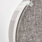 Close-up of a modern air purifier with textured gray fabric and perforated white front, showcasing sleek design and quality materials.