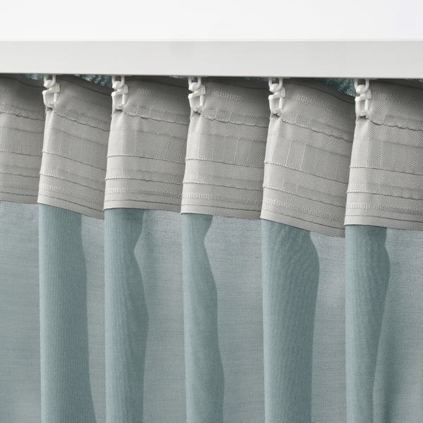 Gray striped sheer curtains with white rings, designed to soften light.