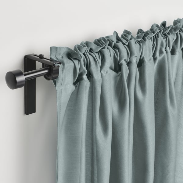 Light blue curtain with black rod and hooks. Provides privacy, softens sunlight, and decorates windows.