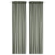 Option: Two green STENFRÖ sheer curtains hang straight, offering a sense of calm. Made from recycled polyester, they diffuse sunlight, adding privacy.