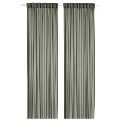 Two green STENFRÖ sheer curtains hang straight, offering a sense of calm. Made from recycled polyester, they diffuse sunlight, adding privacy.