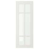 A white STENSUND cabinet door with a grid-patterned glass panel.