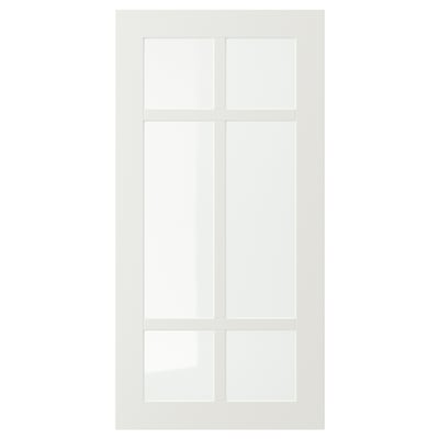 A white STENSUND cabinet door with a glass panel divided into four sections by wooden frames, designed for kitchen use.