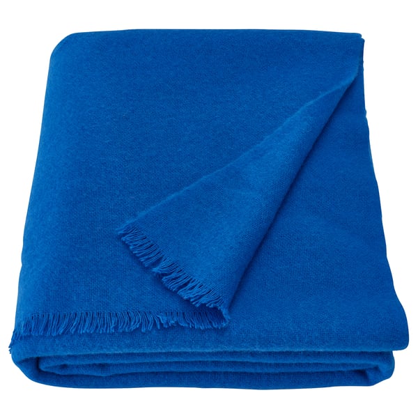 Bright blue wool blanket folded neatly, soft feel, rectangular shape, clean lines, scandinavian design.