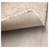 A rug with anti-slip mesh underneath. It appears soft and comfortable, designed to reduce noise and enhance room harmony.