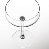 Glass with elegant, wide bowl atop slender stem and round base; pristine, clear, high-quality design.