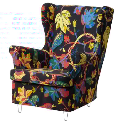 Brightly patterned black armchair with colorful leaf design, high back, and sleek legs.
