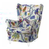 Flowery white armchair, high back, colorful leaf print, wooden legs.