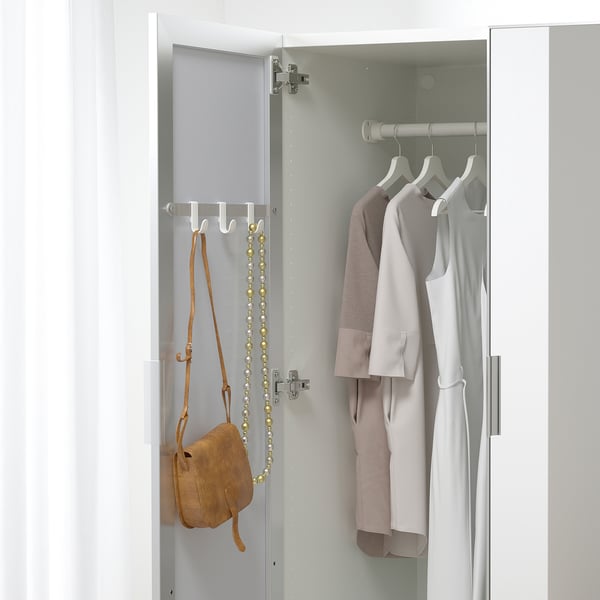 Mirrored wardrobe door revealing clothes and accessories, featuring hooks for bags and jewelry.