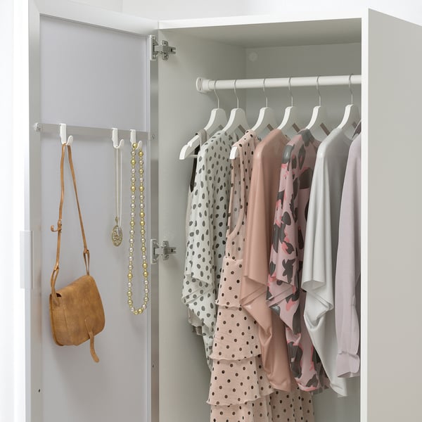 A wardrobe with mirrored door reflecting clothes and accessories, saving space and providing convenience for dressing.