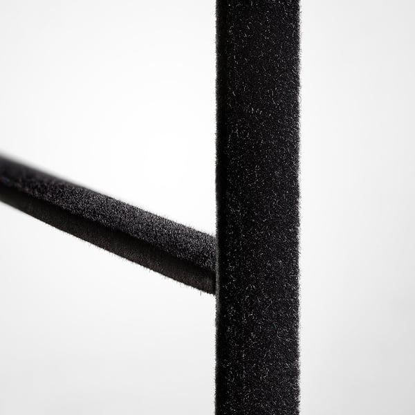 Close-up of velvet trouser hangers soft, black velvety texture, showcasing its smooth and high-quality fabric.