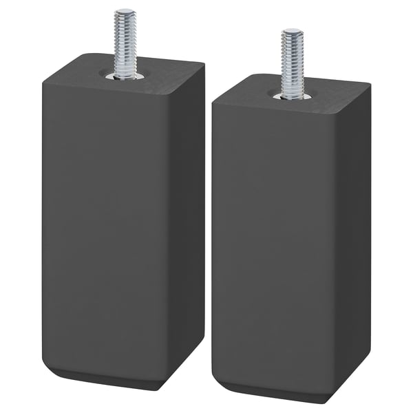 Two STUBBARP legs in dark grey. These are square, wooden furniture legs with adjustable screws for leveling. They have a sleek, minimalist design.