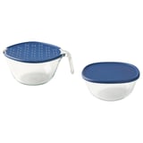 Two glass bowls with blue plastic lids, one with a handle and holes for straining, stacked neatly.
