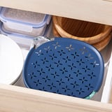 Drawer with blue strainer bowl, lidded containers, and wooden bowl.