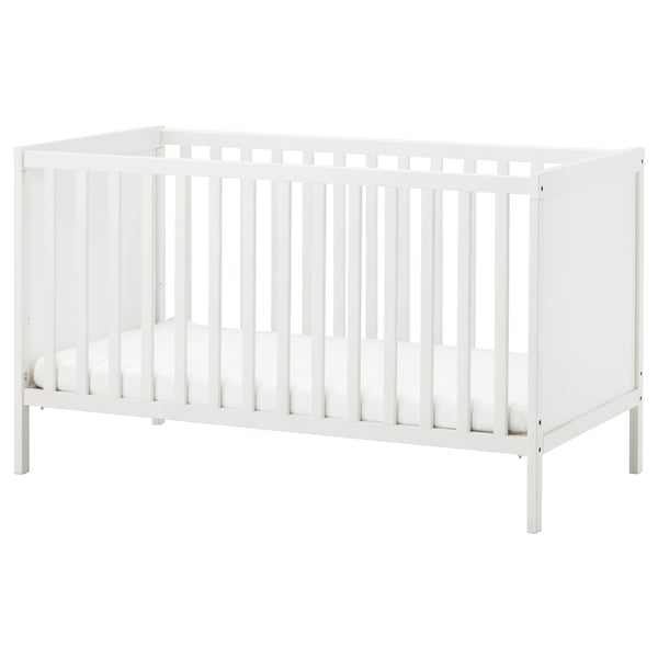 A white SUNDVIK baby cot with vertical slats, sturdy wooden construction, and adjustable base height.