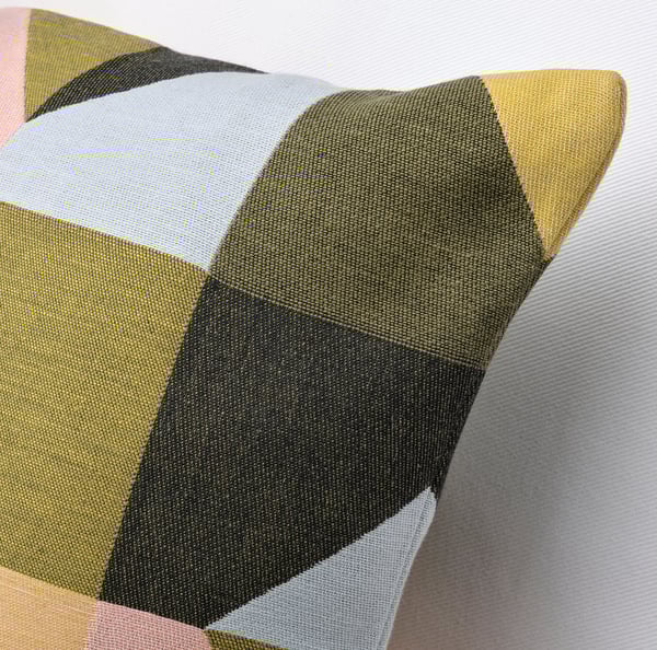 Multicolored cushion with geometric pattern, soft and textured cotton cover.