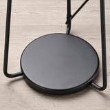 Modern black metal standing lamp with large round shade, sleek and sturdy design.