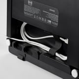 A black ikea SYMFONISK wifi speaker with its back panel open, revealing internal cables and a label with product details.
