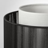 Close-up of black & white SYMFONISK lamp shades, showcasing texture & quality.