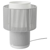 A white SYMFONISK lamp with fabric cover and cylindrical shape, its a wifi speaker with integrated lighting.
