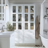 White TÄNNFORSEN bathroom cabinet - tall, multi-shelf & drawer, glass doors, space-saving.