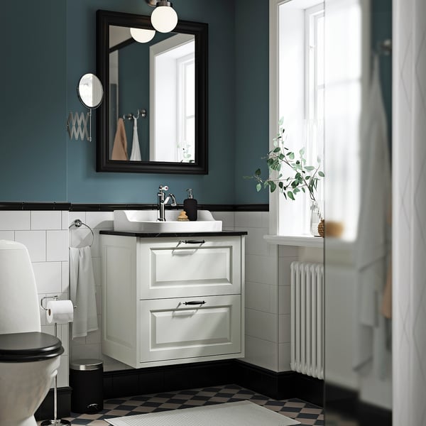 Modern TÄNNFORSEN white cabinet, wall-mounted with black accents and teal walls.