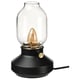 Option: TÄRNABY lamp in black; rounded glass shade tops smooth, dark base; warm, dimmable light.