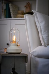Vintage lamp on nightstand with warm light.