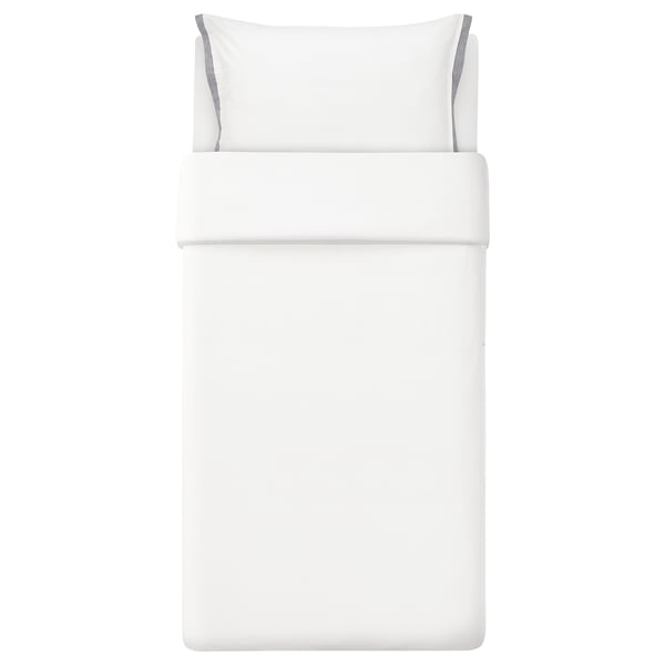 White bedding set with blue trim, made of organic cotton.