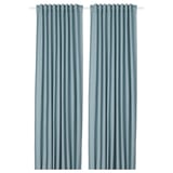 Two solid blue curtains hang side by side. Simple, elegant design with rod pocket top. Ideal for privacy and light control.