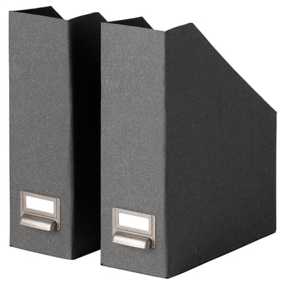 Two black TJOG magazine files upright, rectangular with handles and empty slots for labels.