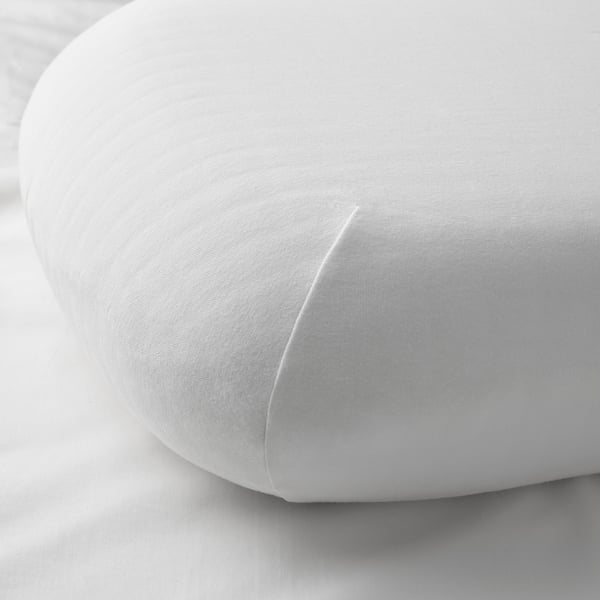 Close-up of soft, white pillowcase with stretchy edges, showcasing quality cotton-blend fabric.
