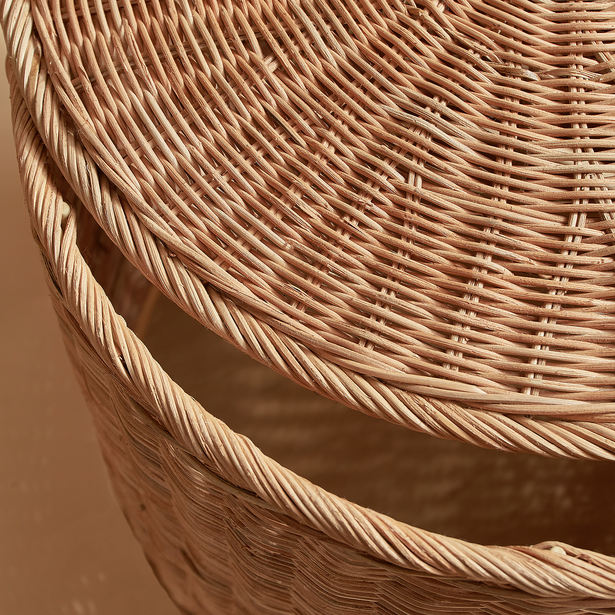 Woven wicker basket detail, tight weave, natural fibers.