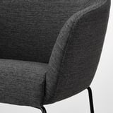 Dark gray upholstered barstool detail, showcasing plush fabric and sleek metal leg.