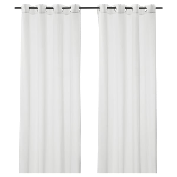 Two white, sheer curtains hang side by side, each with metal grommets at the top, providing privacy while allowing light through.