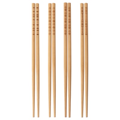 Four pairs of light brown bamboo chopsticks, each with unique etched patterns, standing upright in a neat row.