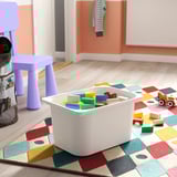 Kids playroom with TROFAST blocks, rug, stool, toy bag, wooden truck.