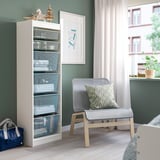 TROFAST white storage unit next to a gray chair.