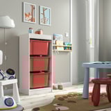 Kids playroom with white TROFAST storage & red bins for toys, bright & organized.