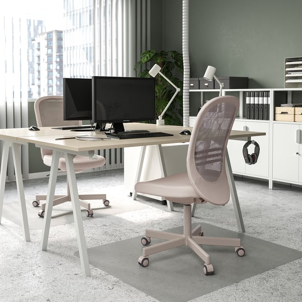 Modern office with TROTTEN desk & chair, city view, two monitors.