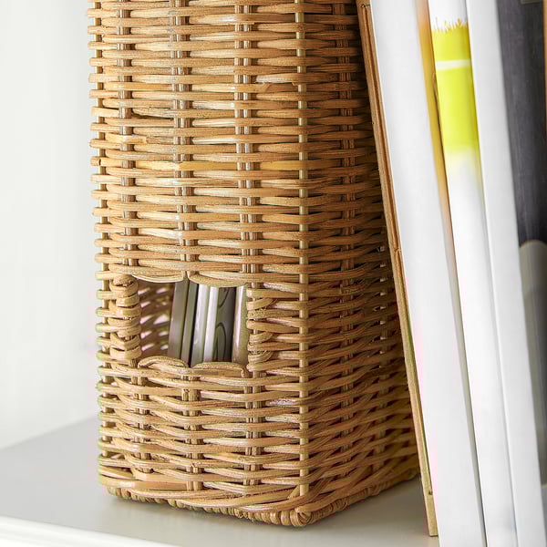 Woven rattan storage basket holds papers neatly, beige color.
