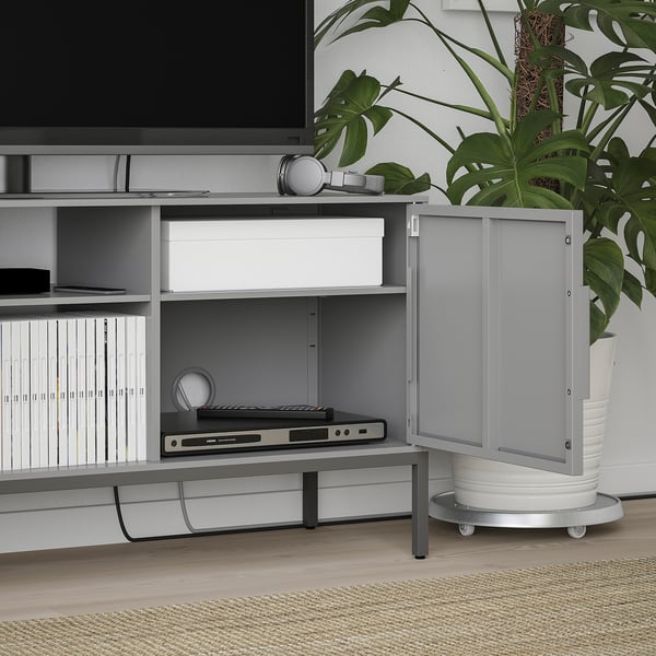 Modern tv stand with bevelled doors, open storage, and cable management. It holds electronics, books, and offers adjustable shelves.