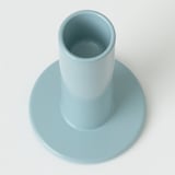 Cylindrical candle holder; smooth, pastel blue finish; sturdy base; superior craftsmanship.