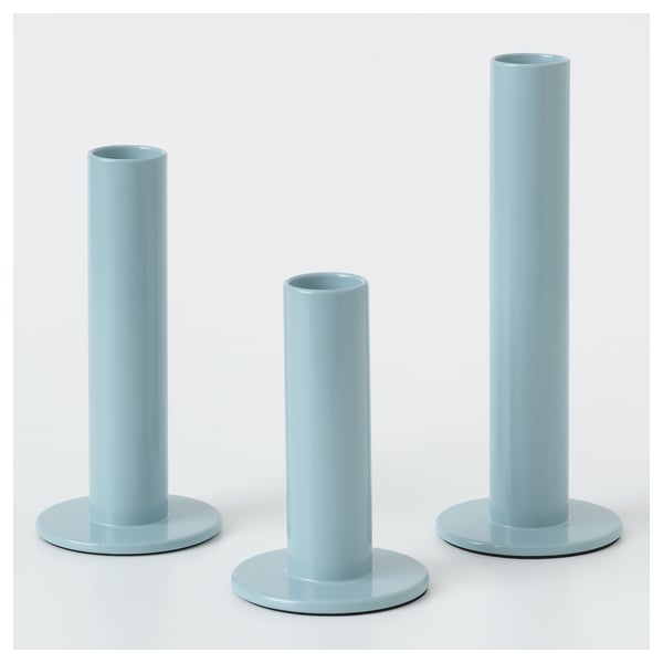 Three blue candles in varying holders by hagberg siblings.