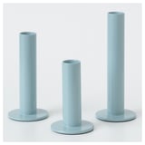 Three blue candles in varying holders by hagberg siblings.